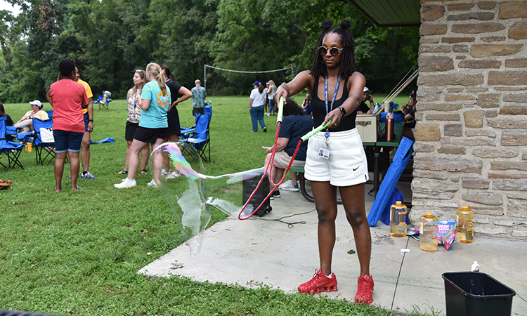 Racheal-Quinn-blows-bubbles Racheal Quinn blows bubbles at French Park