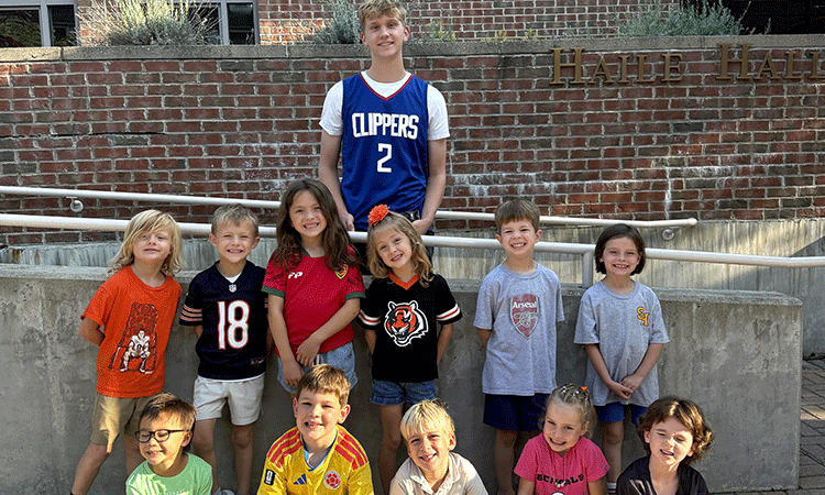 An Upper School student is pictured with kindergarten students