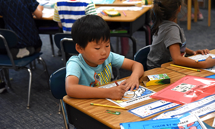 First-grade-color-by-numbers A first grader colors by number