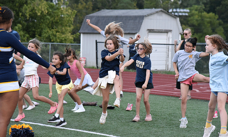 Homecoming-clinics-Doherty-students Students gather on the field for a cheerleading clinic