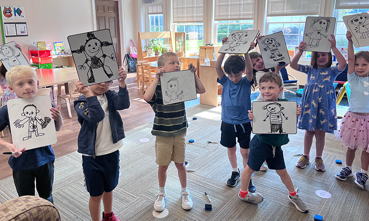 Kindergarten-Self-Portraits_cropped Kindergarteners hold up their self portraits they drew
