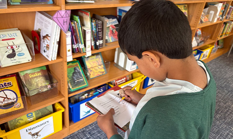 Second-grade-library-scavenger-hunt A student works on a library scavenger hunt