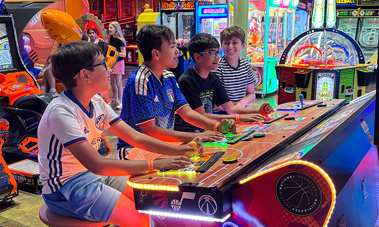 Sixth graders play arcade games at Main Event