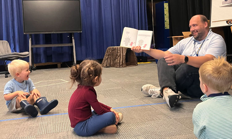 Zack-Fryman-Makes-Students-Laugh A student laughs at Zack Fryman during storytelling